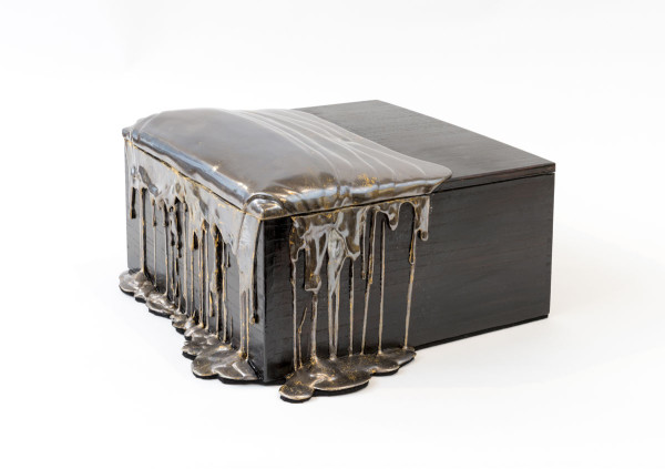 A photo of a sculpture by artist Nancy Lorenz titled "Blackened Silver Pour Box"