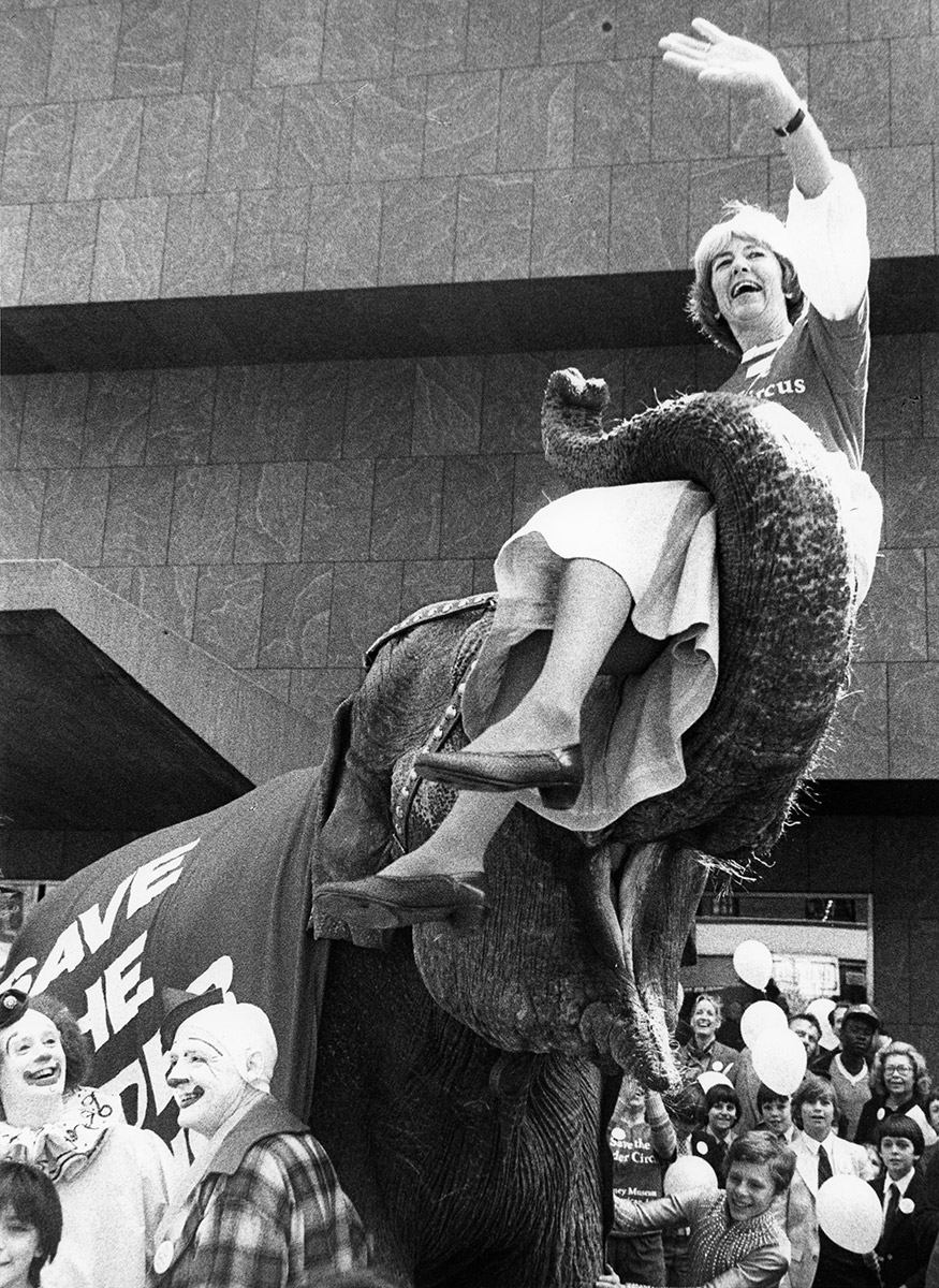 Save Calder Circus press campaign, May 5, 1982. Flora Miller (Irving) Biddle, President of Whitney Museum, riding Targa the elephant in front of Whitney Museum. Frances Mulhall Achilles Library, Whitney Museum of American. Calder Research Archives. Photograph Helaine Messer.
