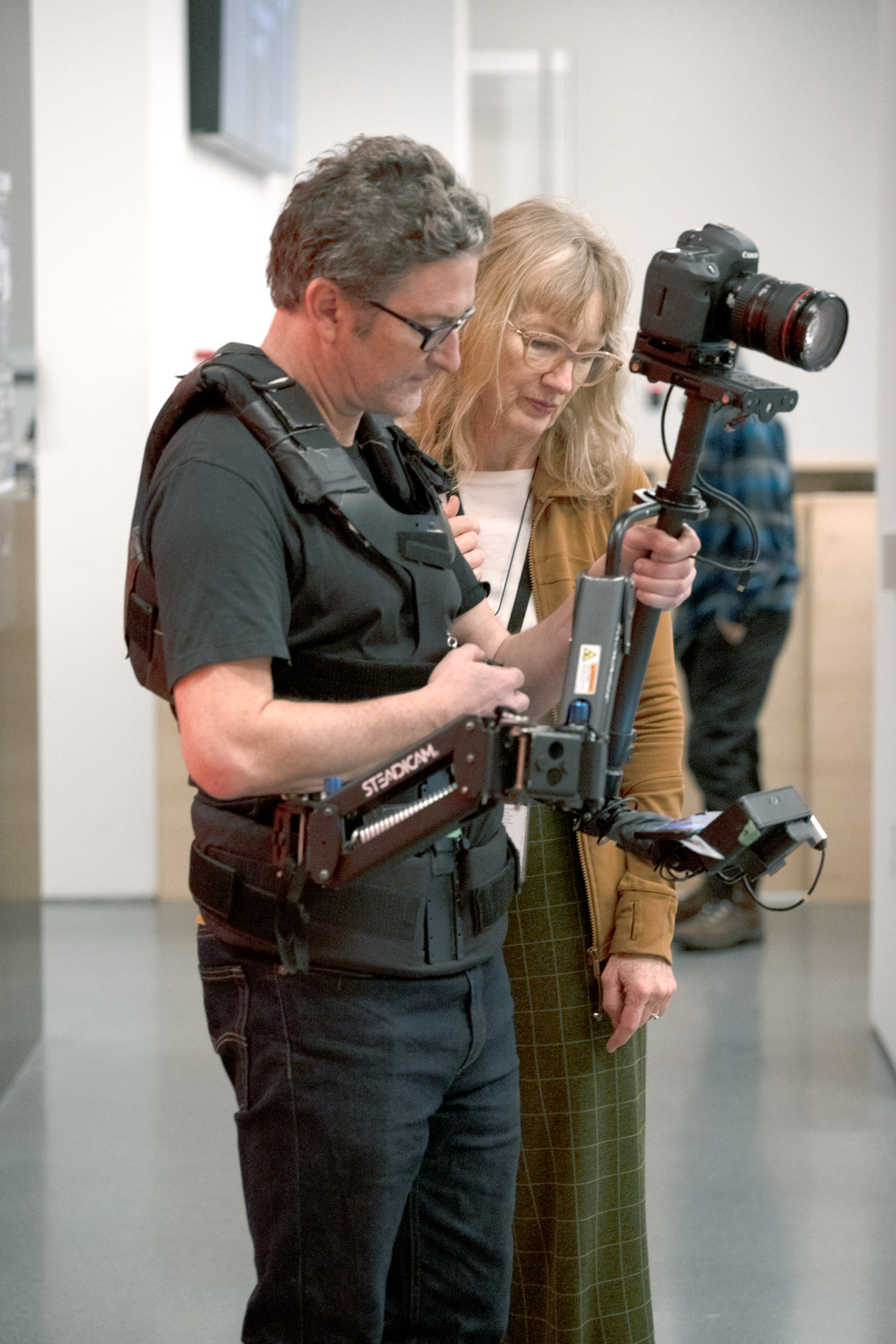 Photo of artists Janet Cardiff and George Bures Miller holding a camera