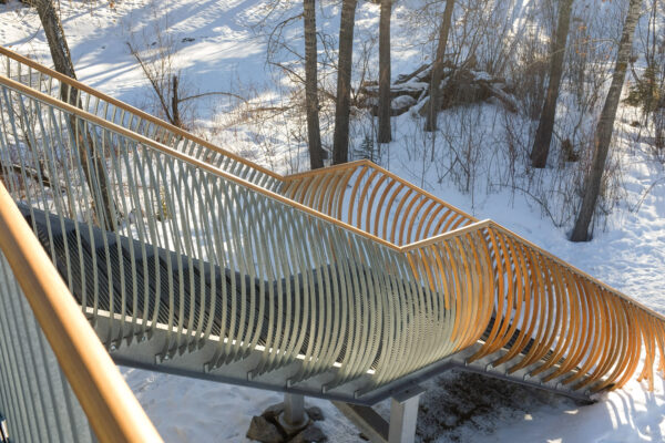 An outdoor metal staircase in a snowy landscape