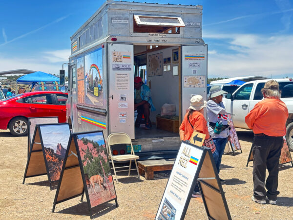 A stepvan with open doors parked in a crowded parking lot