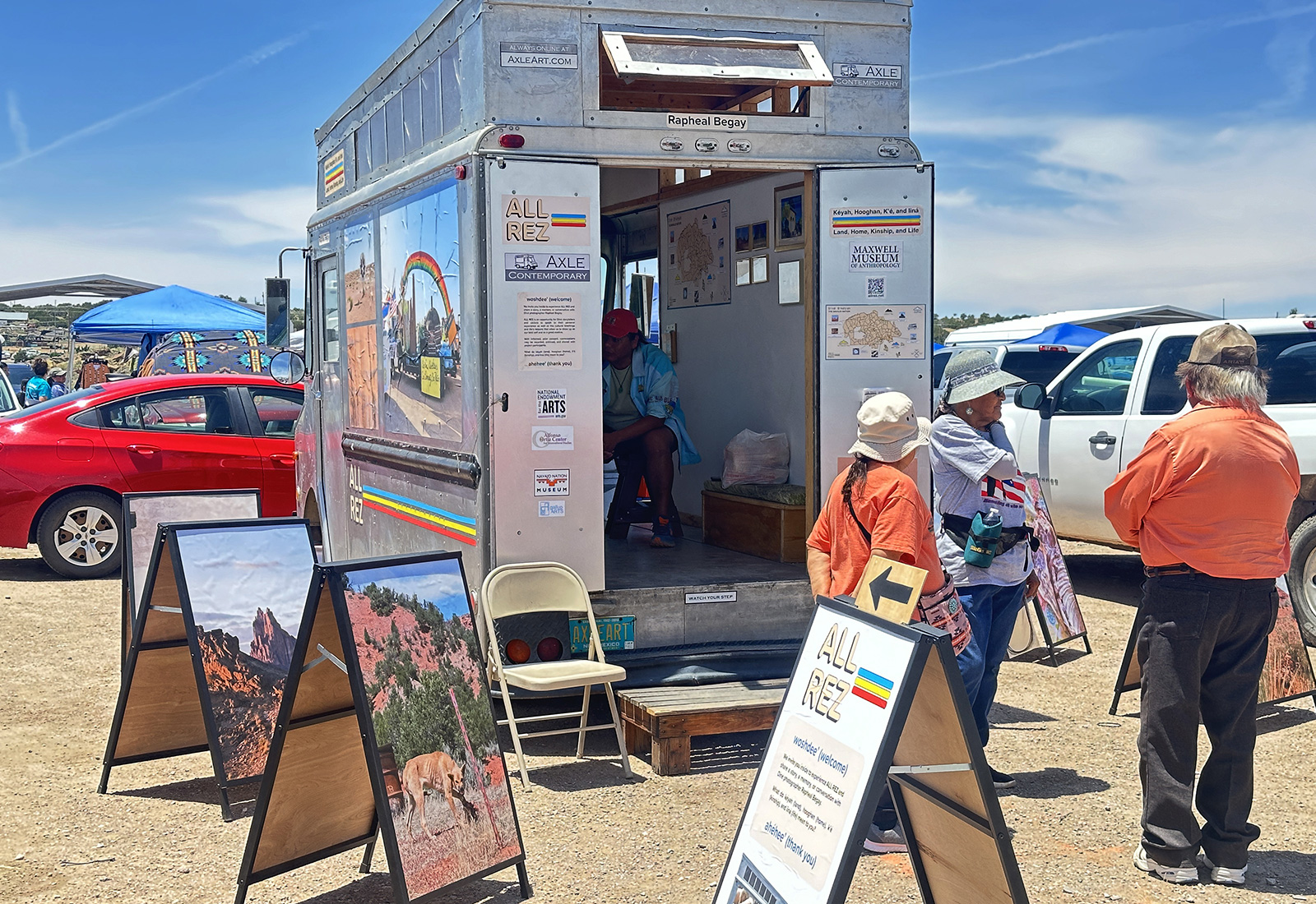 A stepvan with open doors parked in a crowded parking lot