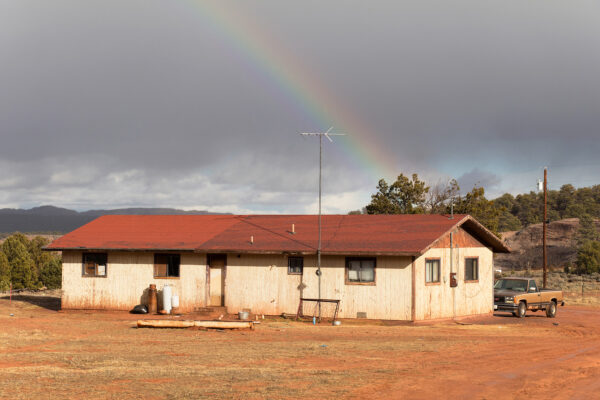 A building on a stretch of open land with mountains in the distance