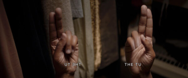 video stills, each with two hands signing and text