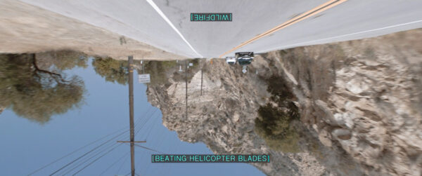 A paved road near a mountain, depicted upside down