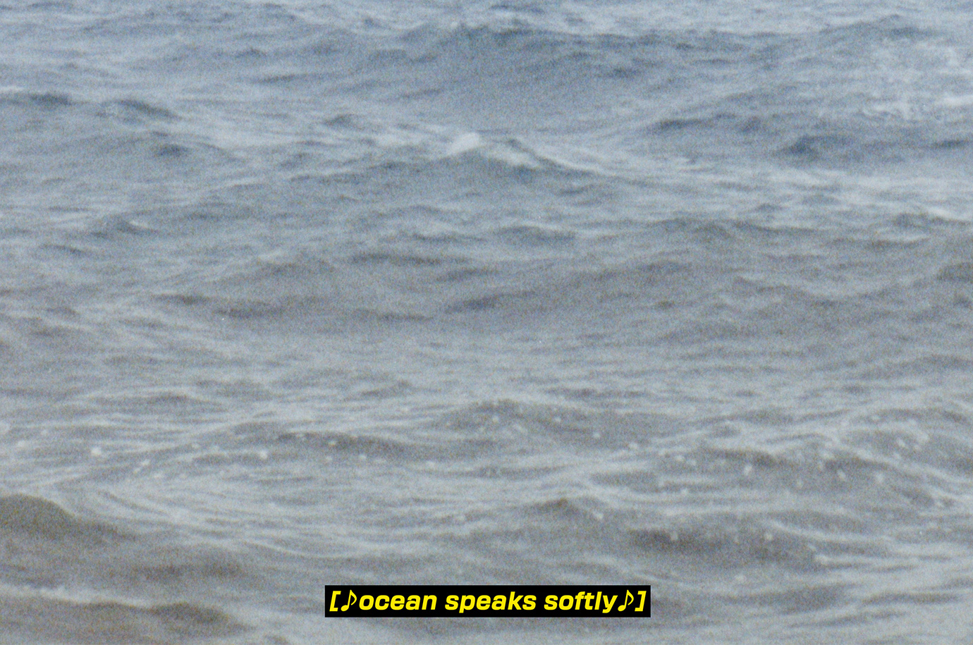 An image of the surface of the ocean, with a caption in yellow