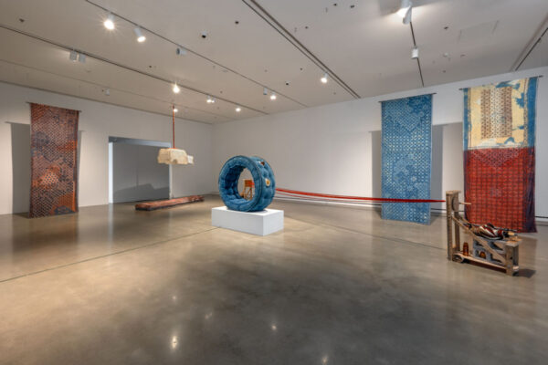 Large-scale textile artworks installed in a spacious room