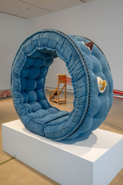 A large textile artwork installed on a pedestal